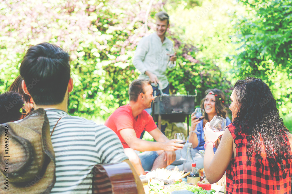 Group of friends having a picnic in a park 