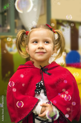 Cute blonde little girl wearing Red Riding Hood costume