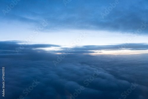 Sunrise above clouds seen through airplane window © Jamo Images