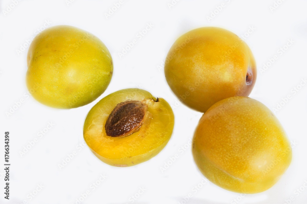 ripe yellow plums on the isolated background