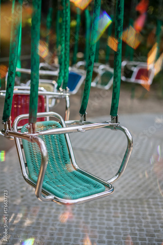 Green empty carousel seat at summer funfair