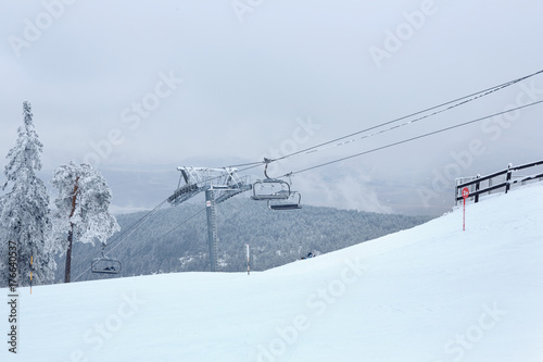 winter mountain landscape with modern ski lift. © Lucky Fenix