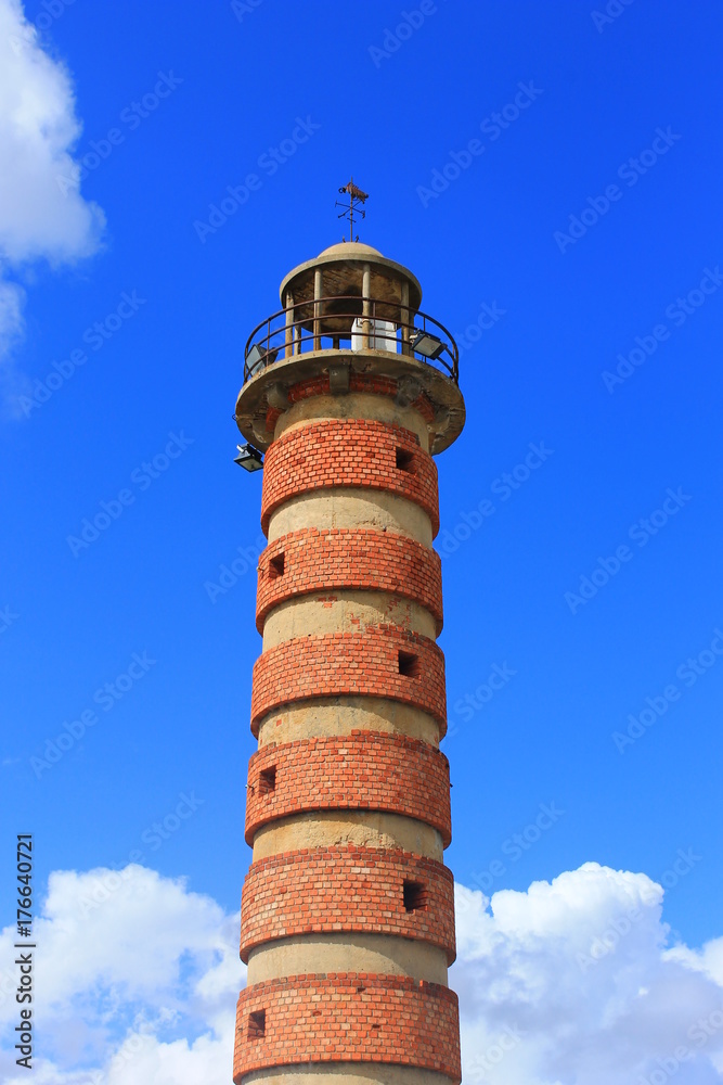 Old lighthouse against bright blue sky