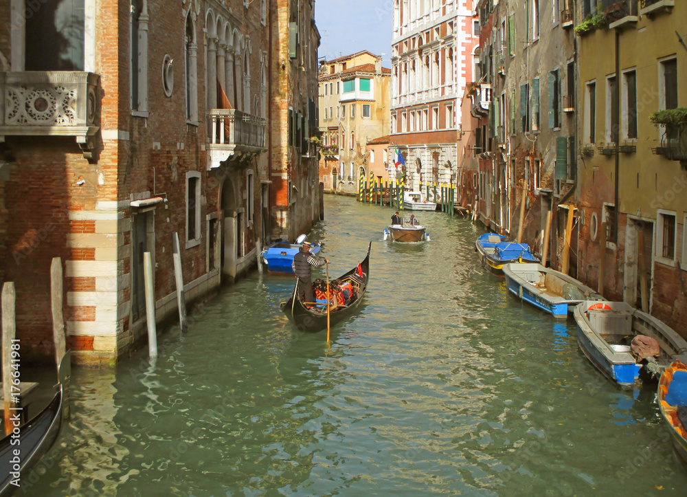 Small Canal of Venice with the Gondola and Another Watercraft on a Sunny Afternoon, Italy 