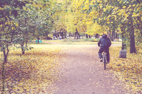 cyclist on a bicycle path in the park in autumn © fedorovekb