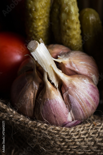 Garlic. Garlic on the bag. In the background vegetables. photo