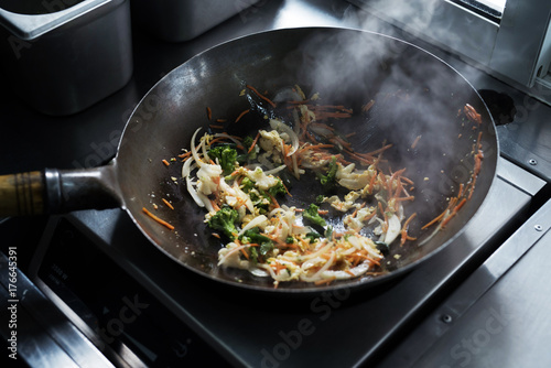 The process of making Chinese noodles close-up. Noodles are cooked in a special wok