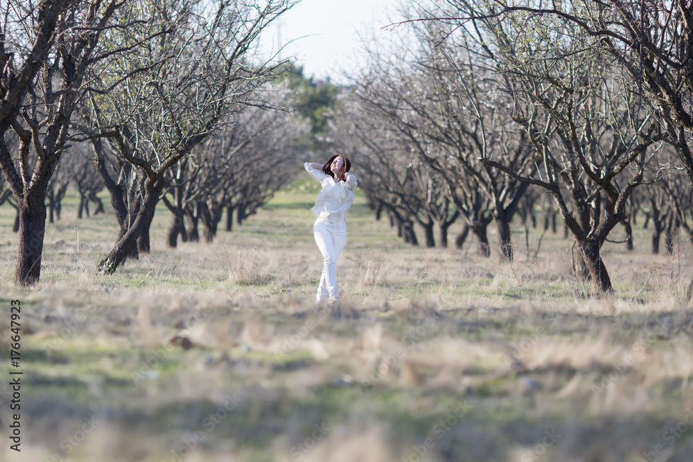 Girl in a neglected almond orchard