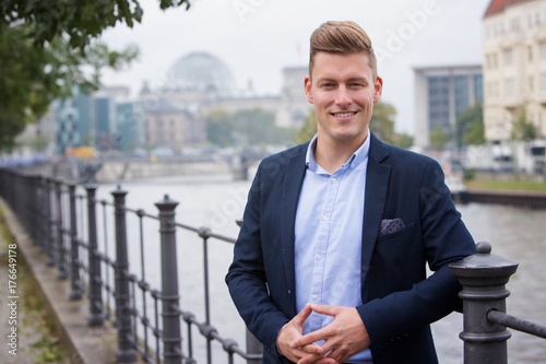 portrait blond man in front of german parliament photo