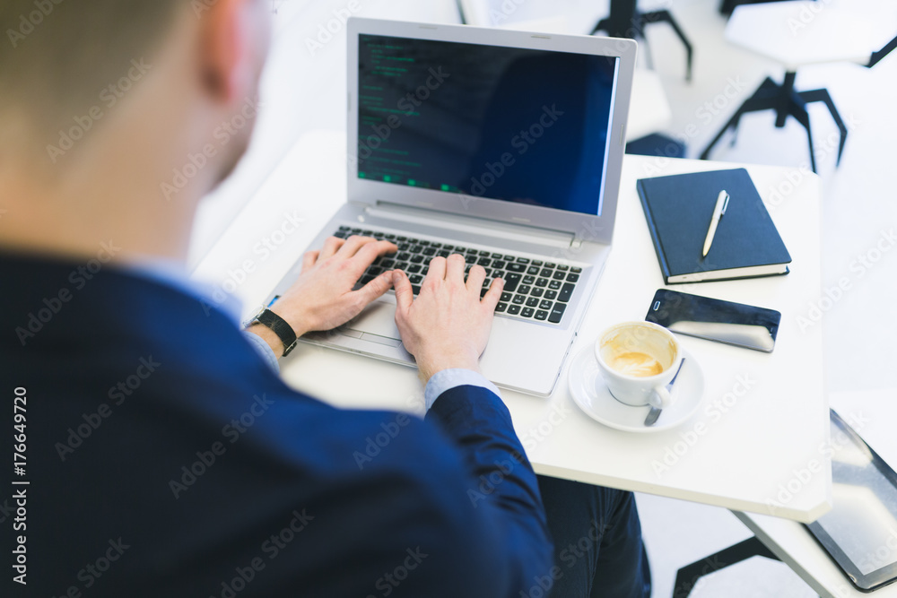 Close up shot of unrecognizable business man hands doing something on laptop or notebook. Modern cafe interior. Working people concept. Close up shot of unrecognizable business man hands doing something on laptop or notebook. Modern cafe interior. Working people concept.