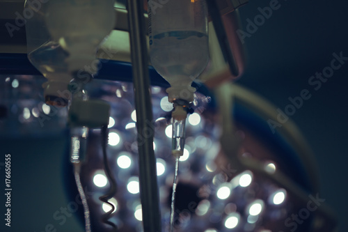 perfusion drip equipment hanging in hospital medical unit, blue background photo