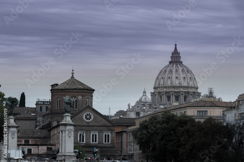 View of the old Roman city's historic buildings and decorated with a dome of a basilica on a gray cloudy day