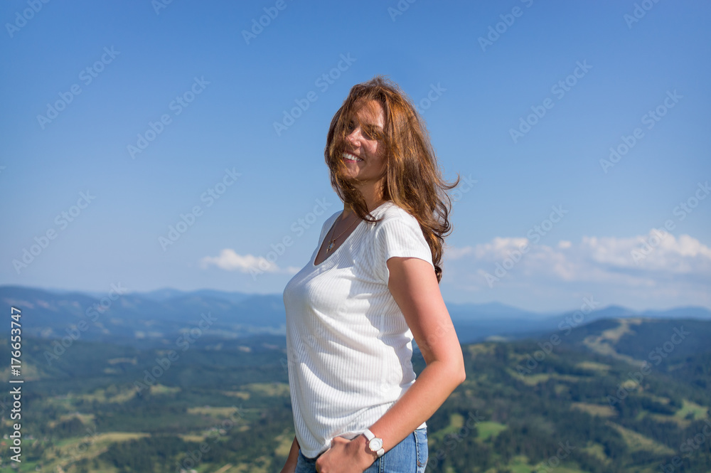 Woman stands in the mountains