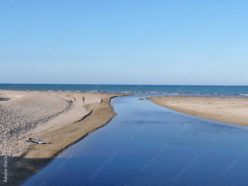 A quiet, small river flows into the Mediterranean Sea A quiet, small river flows into the Mediterranean Sea