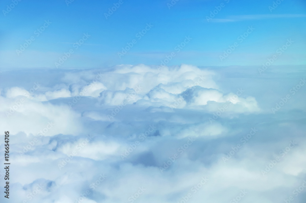 Fototapeta premium Fluffy cloudse viewed from airplane.