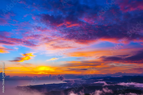 Incredible colorful sunset on the seashore, hills and mountains under clouds of different colors. Big Sochi, Russia.