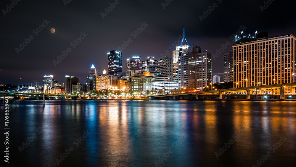 Pittsburgh downtown skyline by night viewed from North Shore Riverfront Park across Allegheny River.