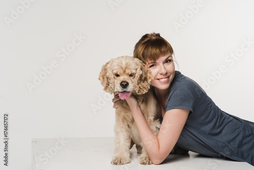 Young woman hugging her spaniel