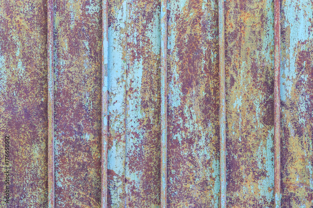 Fragment of the old metal fence painted by blue paint as the background Fragment of the old metal fence painted by blue paint as the background