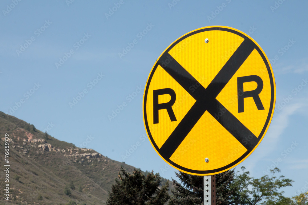 Black and yellow circular railroad crossing sign Stock Photo | Adobe Stock