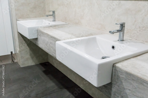 Minimal style bathroom with two sinks and granite top