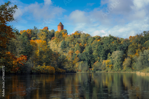  Picturesque view on valley of Gaujas national park. Trees changing colors in foothills. Colorful Autumn day at city Sigulda in Latvia. 