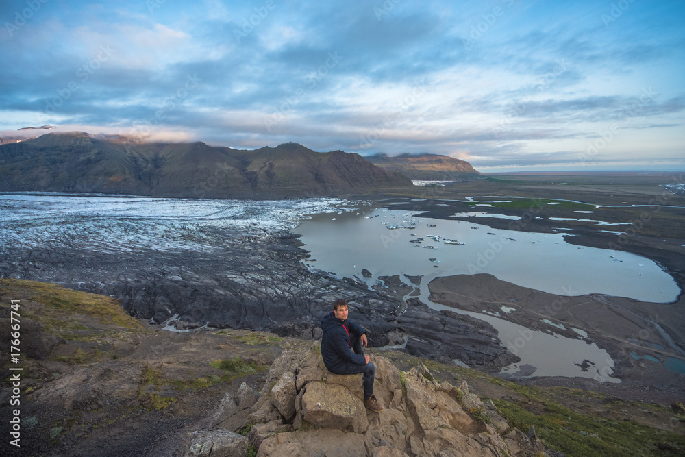 hiking in winter, backpacker enjoying panoramic landscape of glacier in Iceland, Skaftafell