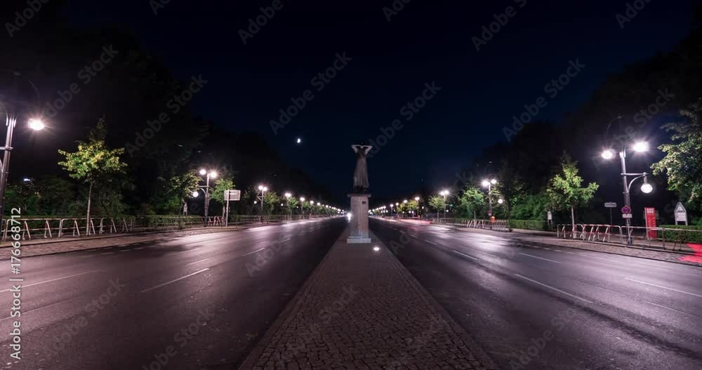 Night timelapse of street traffic near a statue Night timelapse of street traffic near a statue