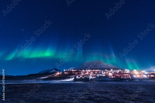 The polar arctic Northern lights aurora borealis sky star in Norway Svalbard in Longyearbyen the moon mountains © bublik_polina