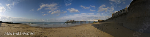Panoram of Cromer beach with groyne and pier in the background © Derek