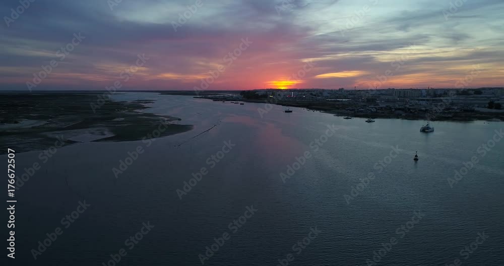 Dusk aerial seascape view of Olhao dockyard, waterfront to Ria Formosa natural park and Armona island. Algarve. Dusk aerial seascape view of Olhao dockyard, waterfront to Ria Formosa natural park and Armona island. Algarve.