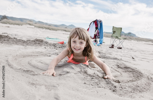 Toddler playing with sand on beach