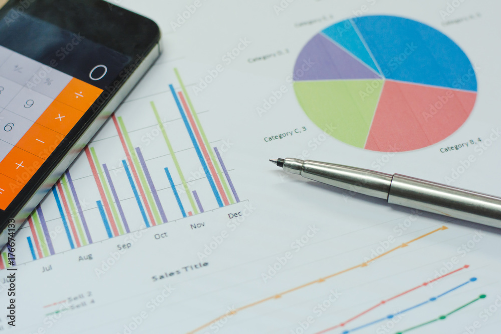 Data analyzing sheet. with calculator mobile phone and pen. from charts and graph to find out the result. Data analyzing sheet. with calculator mobile phone and pen. from charts and graph to find out the result.