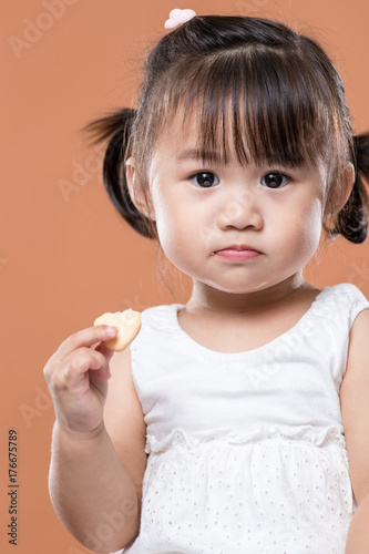 Lovely girl eating biscuit
