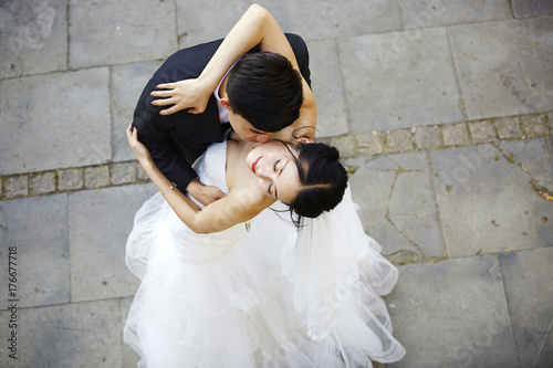 young asian bride and groom dancing photo