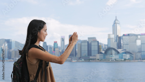 Traveler woman taking photo with cellphone in Hong Kong