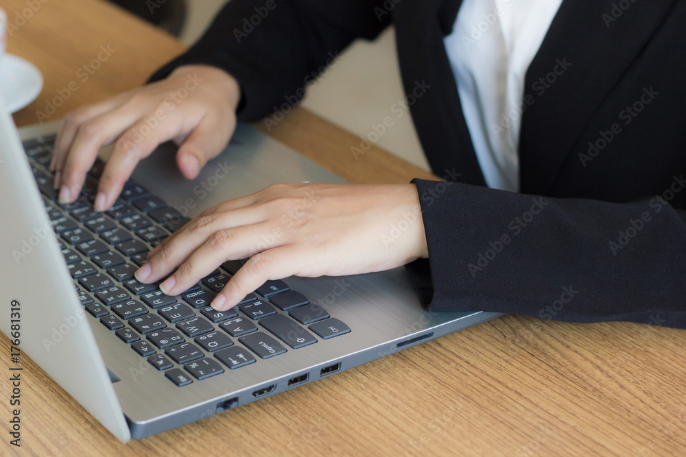 Business woman using laptop checking e-mail or message in office or coffee shop. Laptops are essential in today's work. Portable, convenient to use immediately. Business women an important role today. Business woman using laptop checking e-mail or message in office or coffee shop. Laptops are essential in today's work. Portable, convenient to use immediately. Business women an important role today.