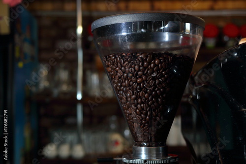 Grains of coffee in the funnel of a coffee grinder coffee machine
