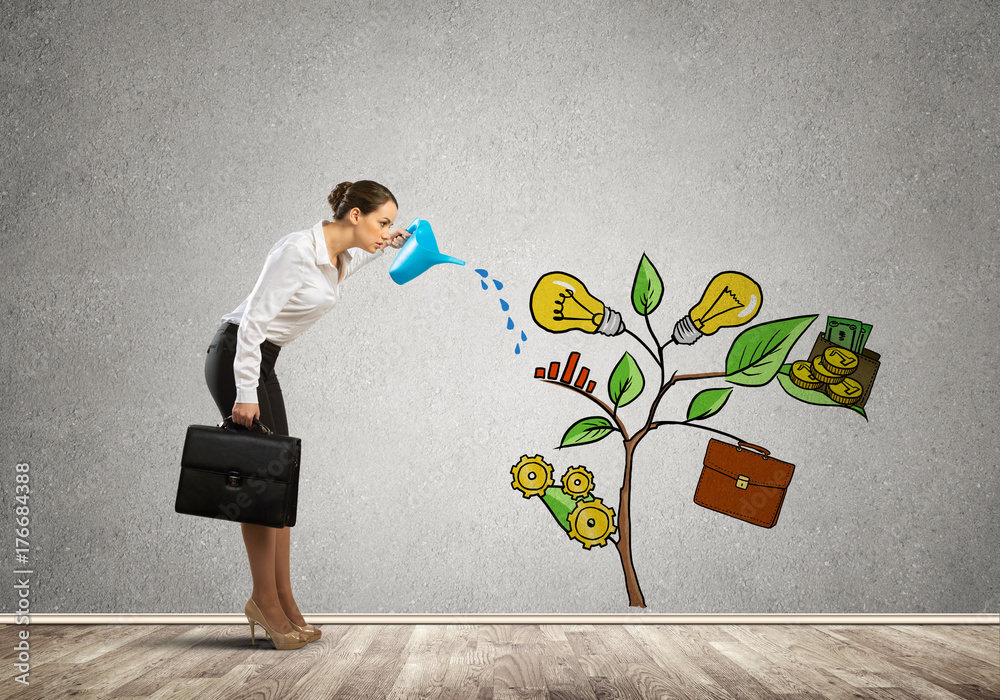 Young businesswoman in empty room watering drawn growth concept with can Young businesswoman in empty room watering drawn growth concept with can