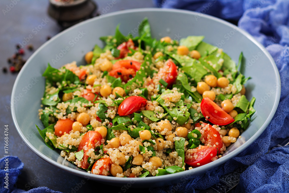 Dietary menu. Healthy vegan salad of fresh vegetables - tomatoes, chickpeas, spinach and quinoa in a bowl.