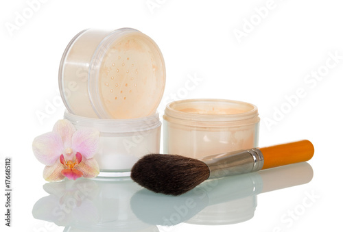 Empty open jars, cosmetic brush and orchid flower isolated on white.