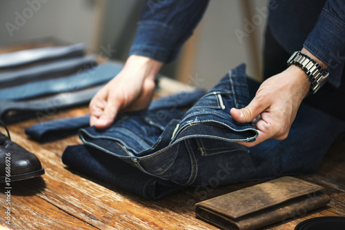 Man folding jeans photo