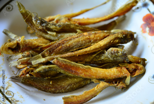 Fresh fried european anchovy on a white plate