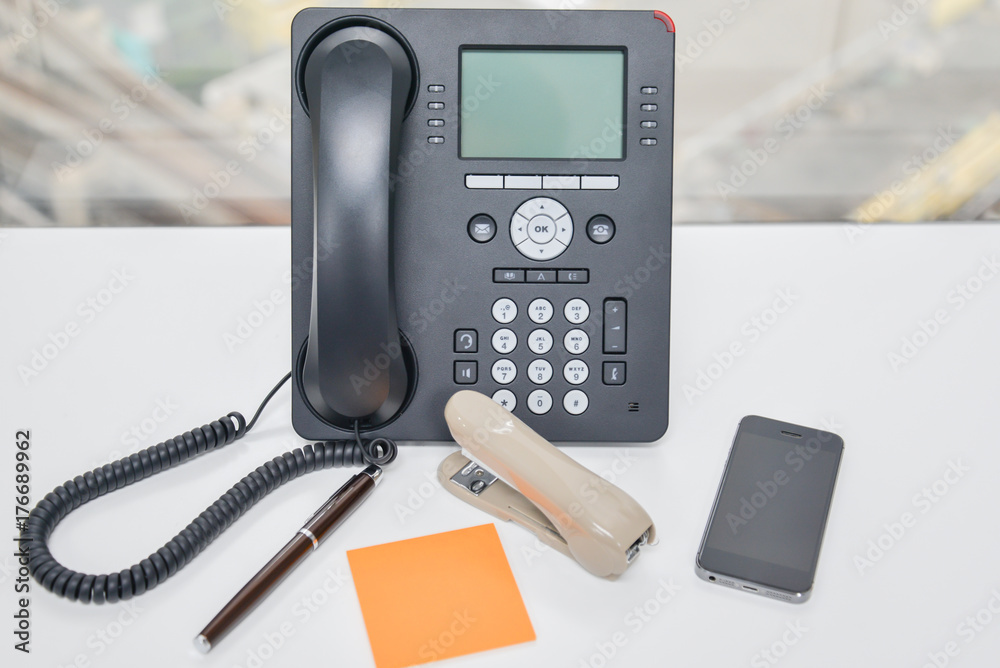 IP Phone and mobile phone and Stapler on the table IP Phone and mobile phone and Stapler on the table