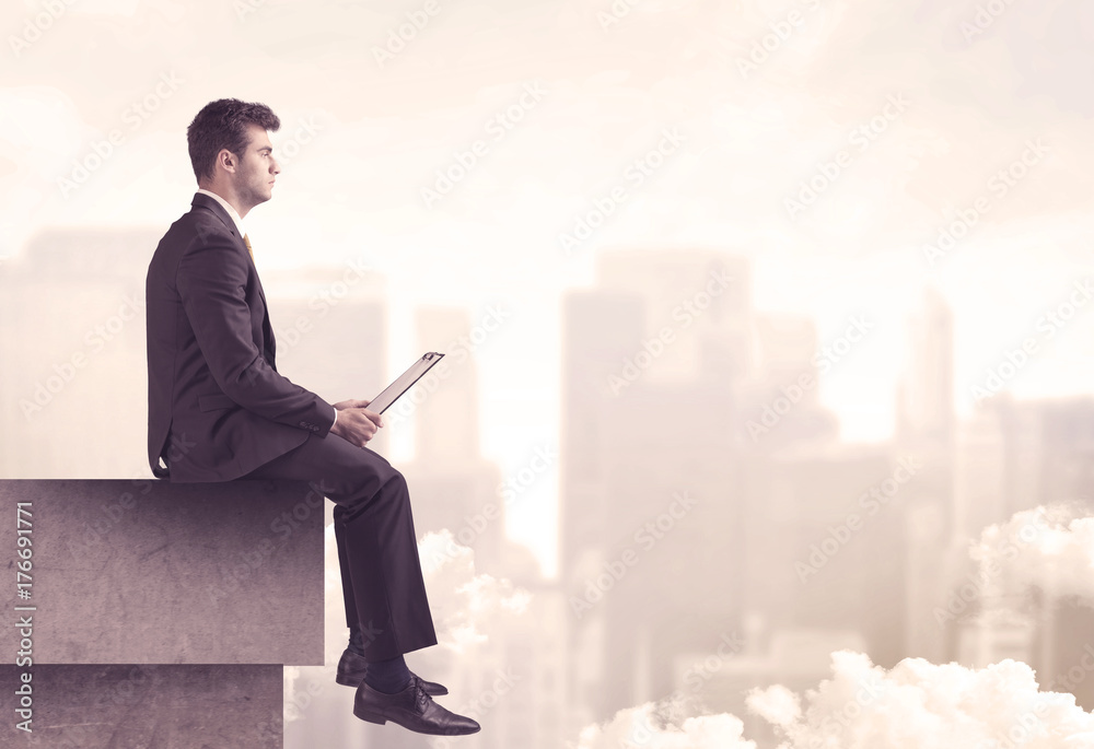 Peaceful sales guy sitting on roof top Peaceful sales guy sitting on roof top