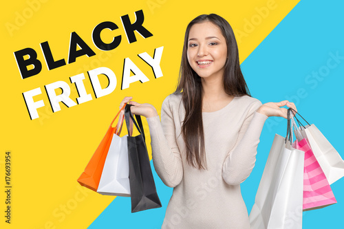 Young woman holding black friday shopping bag