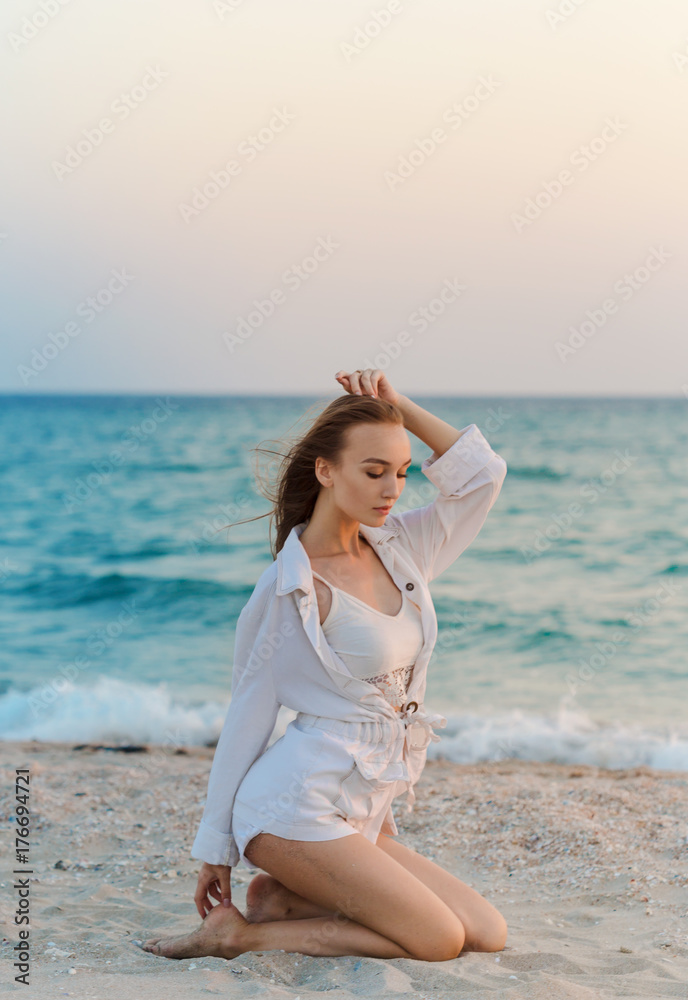 Happy carefree woman on the beach enjoying summer Happy carefree woman on the beach enjoying summer