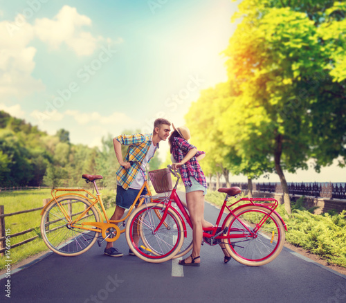 Young man and woman, romantic date on bicycles