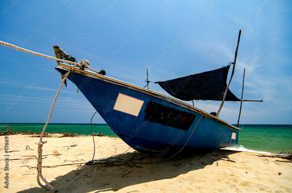 Beautiful scenery, traditional fisherman boat moored over beautiful sea view and sandy beach under bright sunny day Beautiful scenery, traditional fisherman boat moored over beautiful sea view and sandy beach under bright sunny day