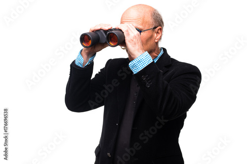 Handsome senior man viewing through binoculars on white background